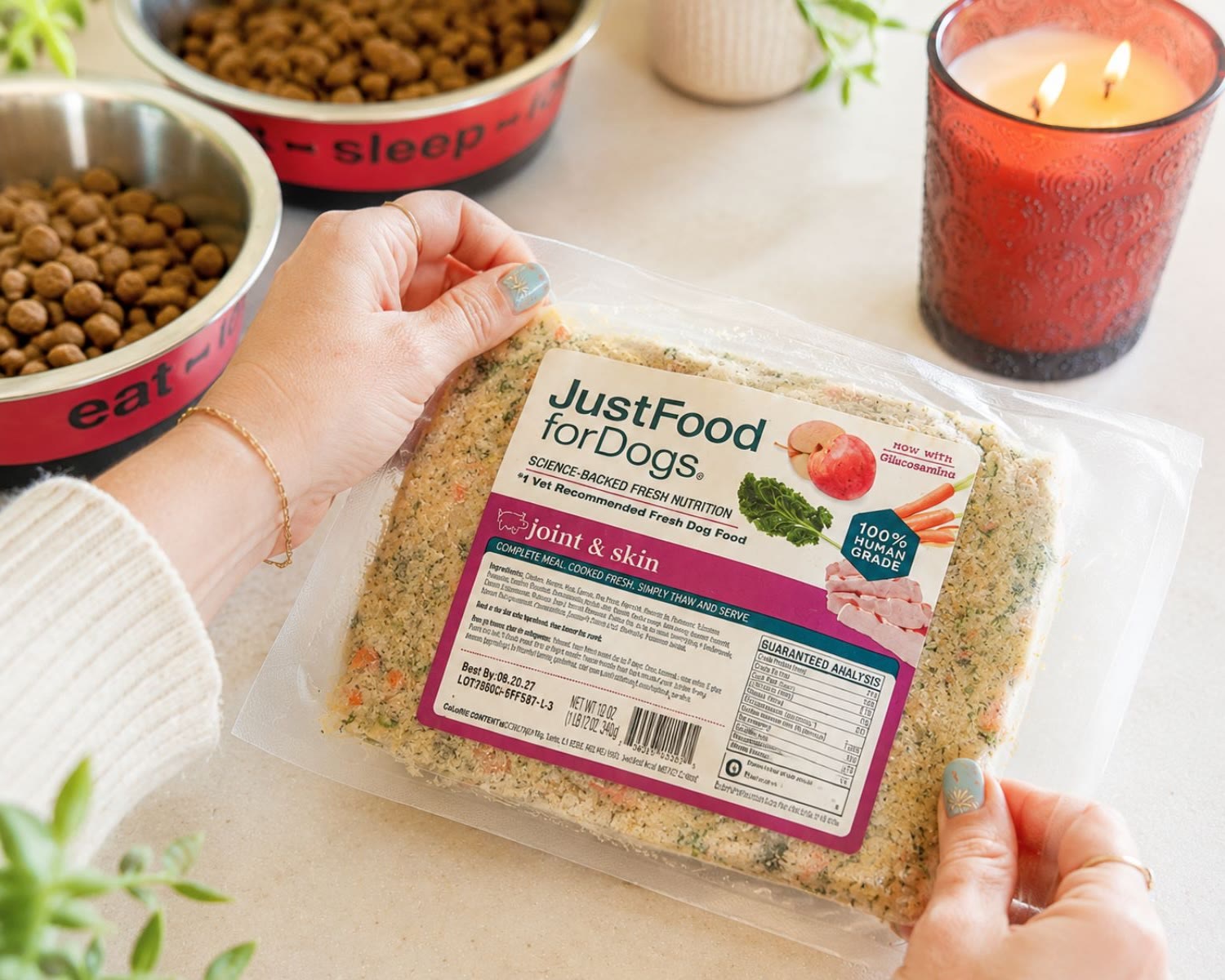 Hands holding a JustFoodForDogs Joint and Skin fresh meal package